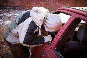 Hooligan smashing windshield