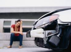Woman with damaged car