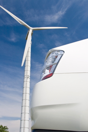 electric car next to a windmill