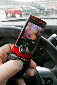 A cell phone is held in a vehicle in Berlin, Vt.
