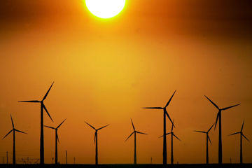 Image Gallery: Renewing the Grid A group of wind turbines are silhouetted by the setting sun on a wind farm near Montezuma, Kan. See pictures of renewing the grid.