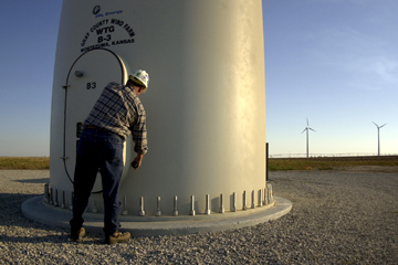 Project supervisor Rusty Hurt opens a door at the base of one of the wind turbine towers in Montezuma, Kan. The wind farm contains 170 of the 289-foot-tall towers and can generate enough electricity to power 40,000 households.