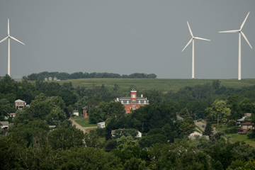 The Atchison County Courthouse is dwarfed by wind turbines in Rock Port, Mo. A wind farm consisting of four 250-foot-tall turbines provide enough energy to power the town of 1,400.