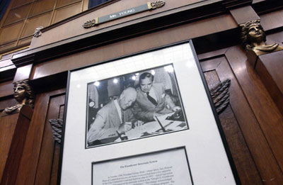A photo of President Eisenhower signing the Interstate Highway Act hangs under the seat of House Transportation and Infrastructure chairman Don Young (R-Alaska).
