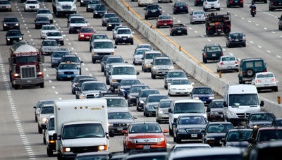 Motorists drive on I-495 in Cabin John, Maryland during Memorial Day weekend 2008. How did American life come to look like this?