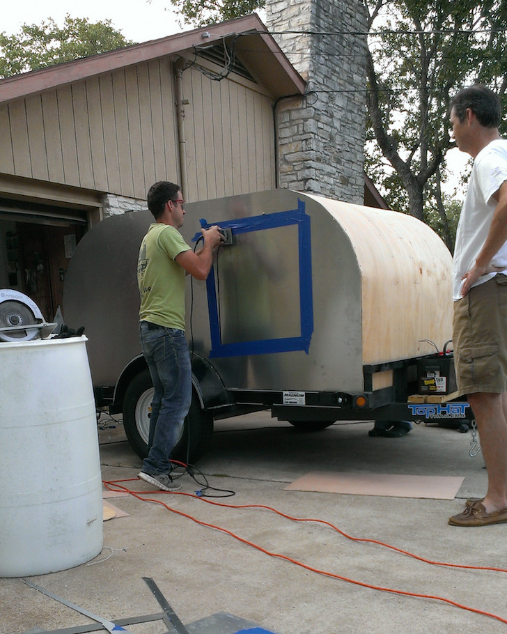 Cutting-out-the-hole-for-the-door-in-the-aluminum-siding
