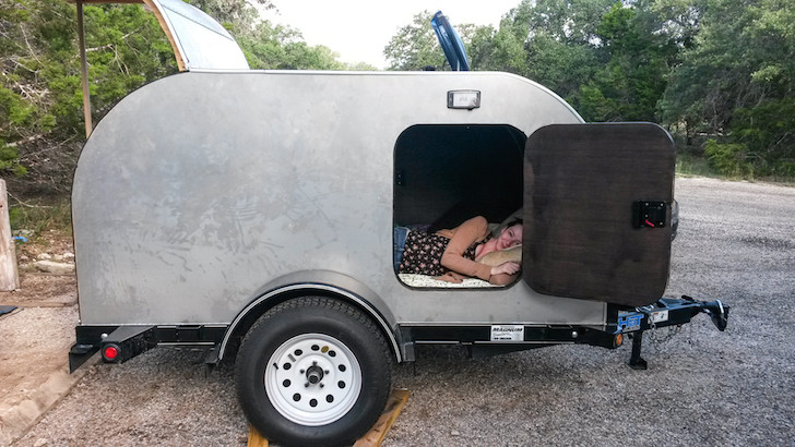 Girl-testing-out-a-tear-drop-camper
