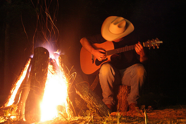 texan-cowboy-playing-guitar-in-front-of-campfire