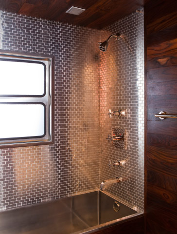 The bathroom features a satinless steel deep soak bathtub