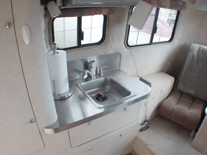 Stainless-steel-sink-in-the-kitchen-of-this-Scamp-fifth-wheel-trailer