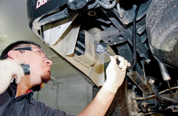 Once the harness is properly connected, run it to the back of the vehicle where the hitch will be installed.