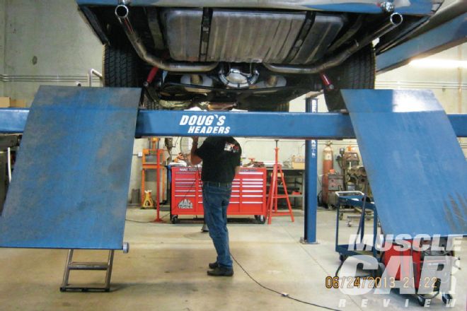 Don Lindfors Examining Oldsmobile Cutlass