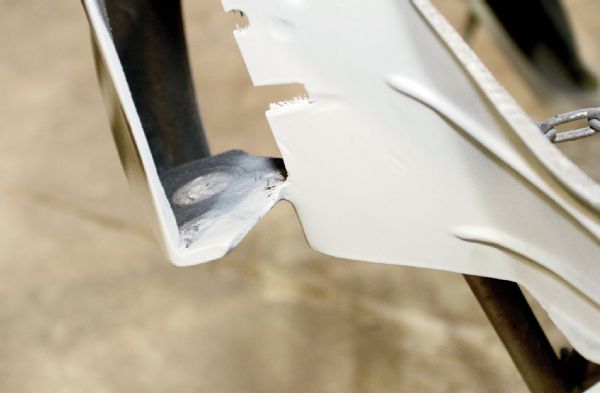 It’s good to check the fiberglass pieces carefully before committing lots of time to painting them. The thin area where the front fenders meet the headlight brackets had some evident cracking. Justin laid on a bit more fiberglass to strengthen the small bridged area.