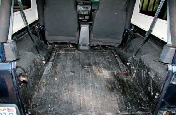 Our ’04 Unlimited was fit with a DIY bed liner, which had seen better days. Using some Simple Green and a brush, we scrubbed and vacuumed the inside of the Jeep to prep for the new BedRug.