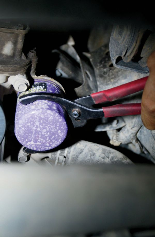 Remove the old oil filter using a small filter wrench, if necessary, and replace with the new filter. You should always lubricate the gasket on the new filter with a small amount of engine oil, as well as put some fresh oil in the filter. Due to the JK’s horizontal oil filter, take care to not over fill it; otherwise, you may be taking a bath sooner than you planned. Never use a wrench or any other tool to tighten the new filter. Hand tighten only!