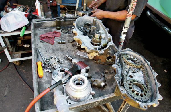 For disassembly of the main case, it is more of the same. Remove all the bolts, and prying as gently as you can, separate the ’case halves. Once you’ve done that, you can lift the chain and gears straight up off the front and rear output shafts. Then it is time to pull the old mainshaft.