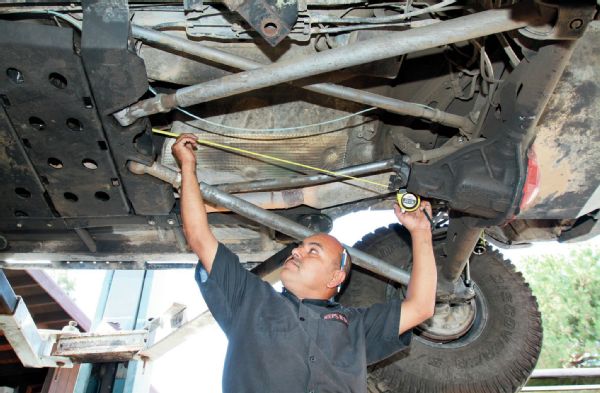 Once the T-case is in the vehicle and everything bolted back down, we measured for a new driveshaft. Since it seemed our old one was too short, we measured at both ride height and full droop.