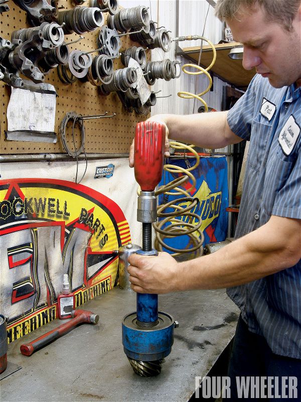 There's more to the disassembly of an axle than you may think. For instance, the bearing caps must be marked so they can be reinstalled in exactly the same position. In addition, careful attention has to be paid to what thickness shims were used from the factory. Most of the time, using the same thickness of shims will get you in the ballpark for reassembly. Here, the old pinion bearing is removed from the pinion shaft so the shim can be removed and measured.