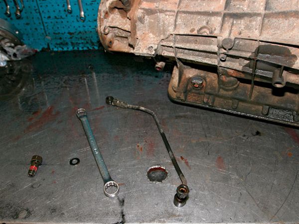2. The first thing Wood explains to customers is where Ford went wrong when they designed the transmission in the first place. Notice the small "bypass" line on the workbench. This line was designed to allow transmission fluid to reach operating temperature quickly after start-up. Basically, it involves an inline check valve that opens up, allowing ATF to bypass the cooling circuit when restrictions are above a specific value, e.g., cold temperatures, or with the addition of extra transmission coolers and/or increased line pressure. This is bad for those of us who like to improve things over stock. Without proper cooling, ATF quickly degrades, causing internal components to wear prematurely.