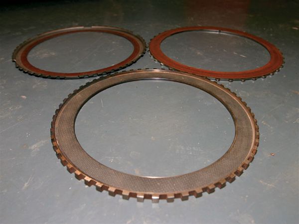 11. Here again are the three converter clutch materials. Notice the difference in color between the Wood unit and the other two. The reason for this is that the Wood clutch is made from a special high-energy material that is super-expensive and long-lasting.