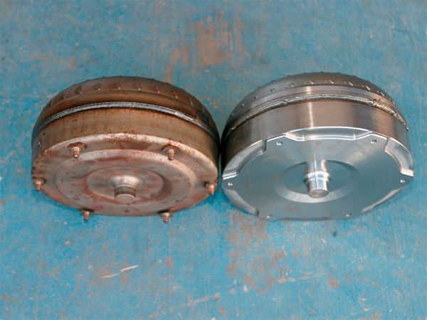 13. Here you can see the difference between a stock torque converter and the Wood unit. The front cover of the Wood unit is a billet-machined piece. This prevents converter housing flex, as well as eliminates the possibility of the converter separating from the flexplate.