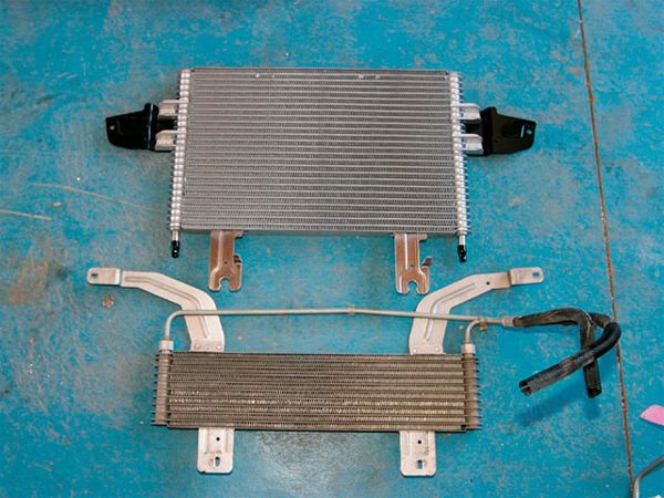 18. After reassembly, Wood replaced the '99 OE transmission cooler found under our donor's truck with the improved type found on newer 6.0L trucks. As you can see, the difference in surface area is obvious; this resulted in a 30-degree temperature drop verses the smaller unit's 15. This upgrade is nice because it bolts on easily in the same location, and uses genuine factory Ford parts.
