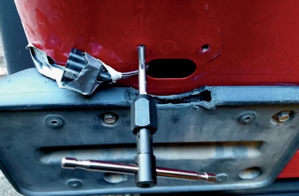 The Trail Tail lights include bolts, which is nice. However, they are of a standard thread, and the holes in the back of this later TJ are metric threads. So, I simply tapped the body to accept the included bolts. Another option would have been to go and get the correct metric bolts. Since this install was done up on a mountain and an hour from the nearest bolt store, borrowing a tap was the better way to go.