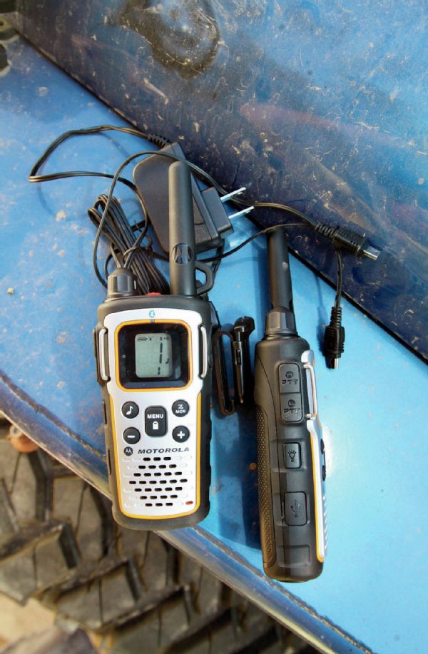 Here is the base MU350 kit: two radios, two belt clips, a charging cable, and two batteries (which I’ve already installed here). The radios charge off of mini-USB so if you have a cell phone charger in your Jeep, you can charge them on the go or at camp. They would also charge off a Motorola docking station. The one on the left, you can see the metal bars to protect the screen and some of the rubber-covered buttons. On the right, you can see the high- and low-power transmit buttons. The radio can access weather stations, it has privacy codes so people can’t listen in, and can be placed in vibrate mode. There are too many features to list, so just Google “Motorola MU350” and you’ll see them all.