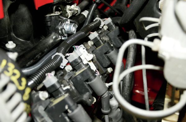 Near the radiator cap, the top hose was routed to the factory overflow bottle. The lower hose is the steam line that connects to the throttle body on these engines. The steam line is important on GM LS engines and is used to purge air from the engine coolant system and to route coolant to the throttle body.