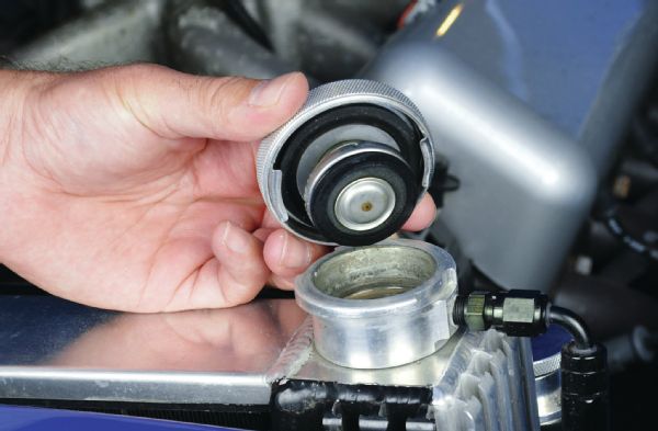 The radiator cap is another simple item that we often see problems with. The cooling system is pressurized; a 50/50 mix of water and coolant boils at 220 degrees Fahrenheit without any pressure, and the boiling point increases about 2 degrees for each pound of pressure in the system. Using a 16-psi cap raises the boiling point to about 250 degrees. Increasing the pressure beyond what your cooling system is designed for can cause leaks or failures elsewhere in the system. But if you’re factory cap was rated at 20 psi, and you have an 11-psi cap on it now, you’ve decreased the capability of your cooling system.