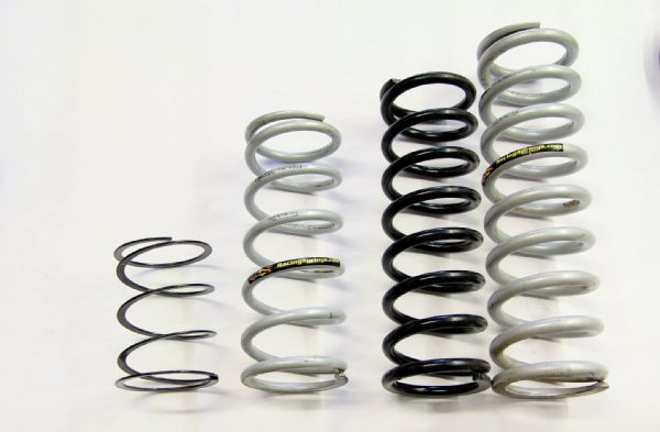 Another way to dial in your coilover is through spring rates. Getting the best spring rates for your rig is a combination of black magic, geometry, testing, and a little luck. Starting from left to right, we have a tender coil, 10-inch primary, 12-inch primary, and 14-inch secondary spring. For a 12-inch-travel coilover such as ours, we suggest going with a 14-inch secondary coil spring. For the primary, it will largely dependent on spring rate and the desired ride height of the Jeep. We’ve decided to remove our tender coil and 10-inch upper in favor of a 12-inch length coil. The 12-inch-lengh coil still has the same 150-pound spring rate as the 10-inch coil we were using, but the 12-inch allows us to get rid of the tender coil. The tender coil is used to keep pressure on the primary and secondary coils so they don’t become unseated at full droop. The tender requires an additional coil isolator, whereas with a longer coil, one was not needed in our case. The goal here is to get usable up travel, with a ride h