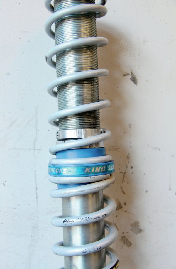 Most coilovers (right) are designed to be a dual-rate shock. This means your rig uses a softer primary spring (upper) and stiffer secondary spring (lower). As soon as you kick up speed or hit a large bump, the secondary (lower spring) moves up and contacts the secondary adjusters/stops. With a secondary coil rate of 300 pounds and primary rate of 150 pounds, we can get a smooth low-speed ride but still have enough rate in the secondary to go fast and take harder hits. Since the secondary adjusters can be easily moved up or down the body of the shock, you can fine tune when the secondary comes in.