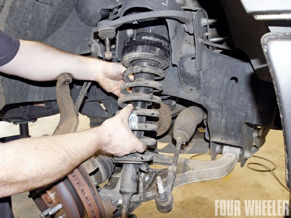 Reassembly of the front suspension is a reverse of the disassembly. The previously mentioned hex counter-bores in the spacers allow tightening of the six new 3/8-inch flanged lock nuts on the upper strut towers without having to use a wrench on the bolt heads.