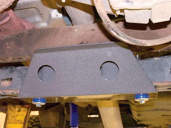 The torsion-bar crossmember is lowered using extension links. A torsion-bar guard (shown) is installed using the OE skidplate bolts.