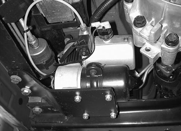 You can mount the electric air compressor anywhere it will be protected and has space to fit. We don&#146;t know about you, but we hate hearing electric pumps cycle on and off on our tow rigs. We&#146;ve found that one of the best places to mount the compressor is on a framerail. This way the truck&#146;s body mounts will isolate the driver and passengers from the noise and vibration these babies make. Here you can see how the pump is mounted up high and protected by the transmission crossmember and its own small skidplate.